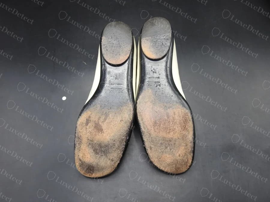 Counterfeit Prada loafer sole, flat leather stamp reading "PRADA / VERO CUOIO / MADE IN ITALY" in a four-line stacked layout