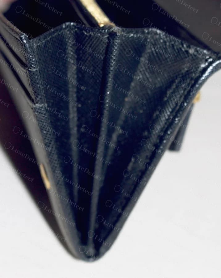 Prada wallet interior card slot construction, authentic — clean tapered seams, tight even stitching