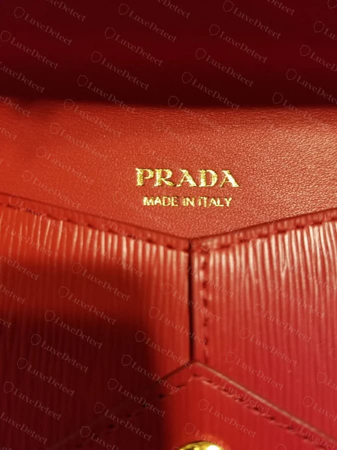 Prada wallet interior hot-stamp, authentic — crisp, evenly struck "PRADA MADE IN ITALY" gold foil lettering
