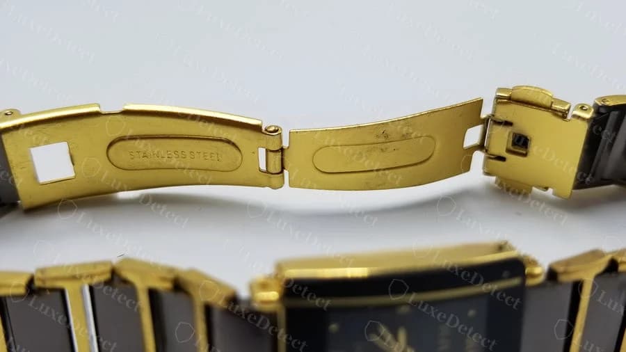 Counterfeit Rado Jubilé clasp link stamped only "STAINLESS STEEL" in a plain oval, with no RADO branding anywhere on this link