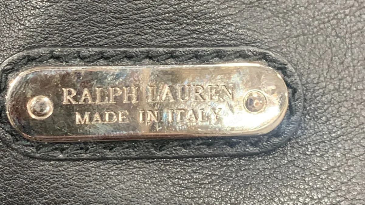Genuine Soft Ricky interior: oval metal plate engraved RALPH LAUREN / MADE IN ITALY with a screw at each end, set into stitched black leather