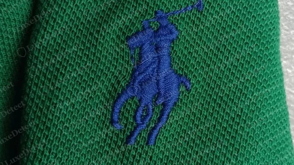 Genuine Polo Ralph Lauren small pony embroidered in royal blue on green cotton piqué: the rider, the raised mallet and the horse's legs each read as separate, densely stitched shapes