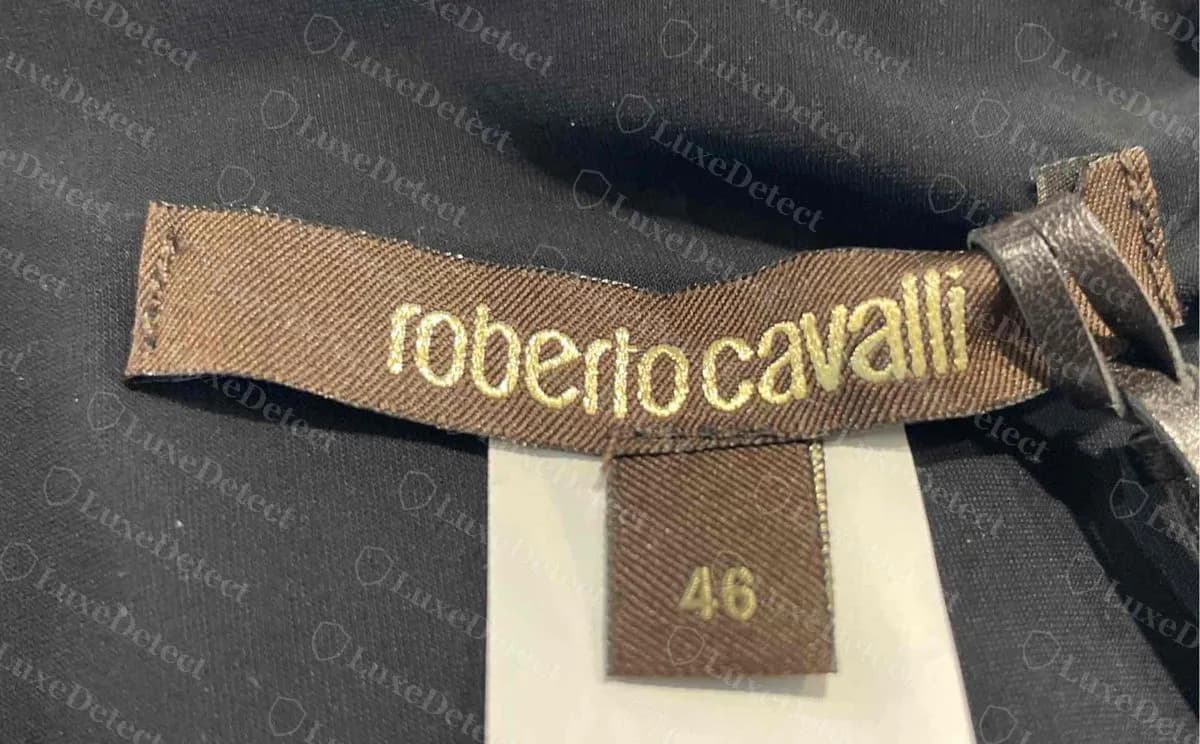 Genuine Roberto Cavalli brown woven neck label reading roberto cavalli in gold lowercase script, with a separate white size tab showing 46, on a black leopard-print dress