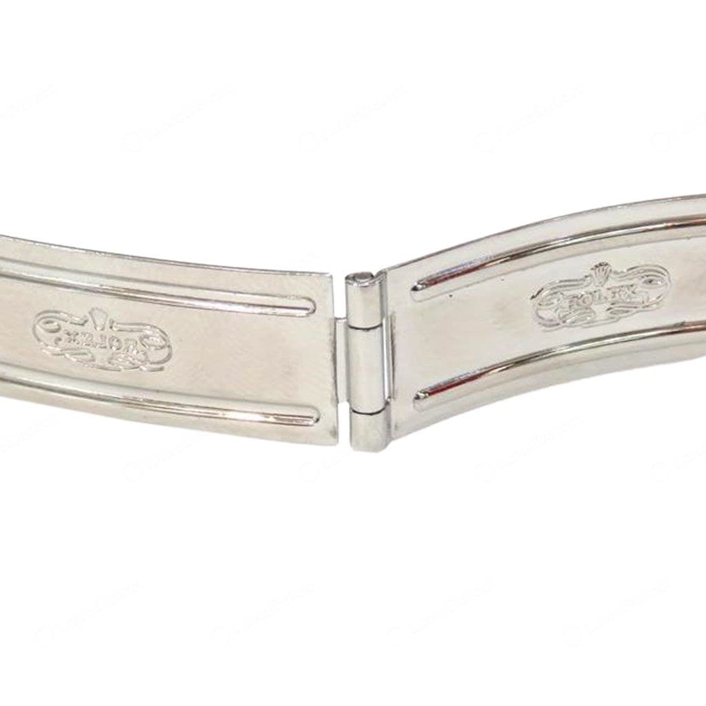 Counterfeit Rolex clasp — scroll cartouches with garbled, barely legible lettering (the left one hardly reads as ROLEX) and a bright mirror polish