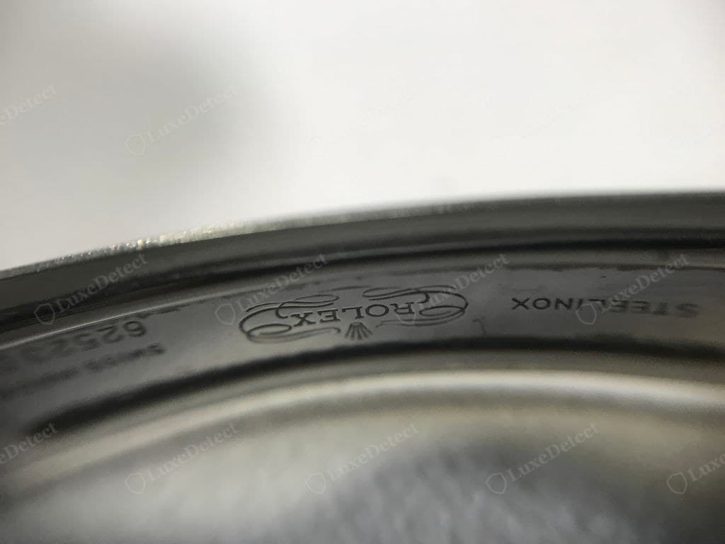 A genuine vintage Rolex clasp — the ROLEX scroll cartouche and "STEELINOX" stamped (not laser-etched) into the clasp, outlines crisp and clean