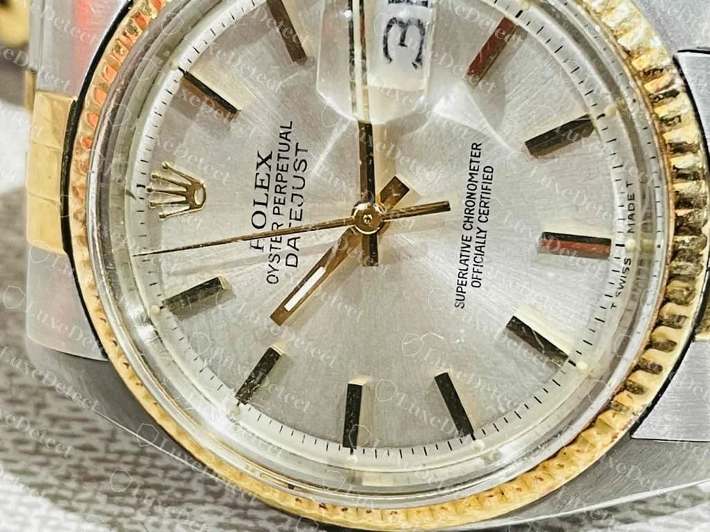 Esfera original de un Rolex Datejust vintage: índices de barra aplicados y nivelados, texto impreso fino, un logo de la corona nítido y puntos luminiscentes en la escala de minutos; en este ángulo las agujas tapan parte del texto
