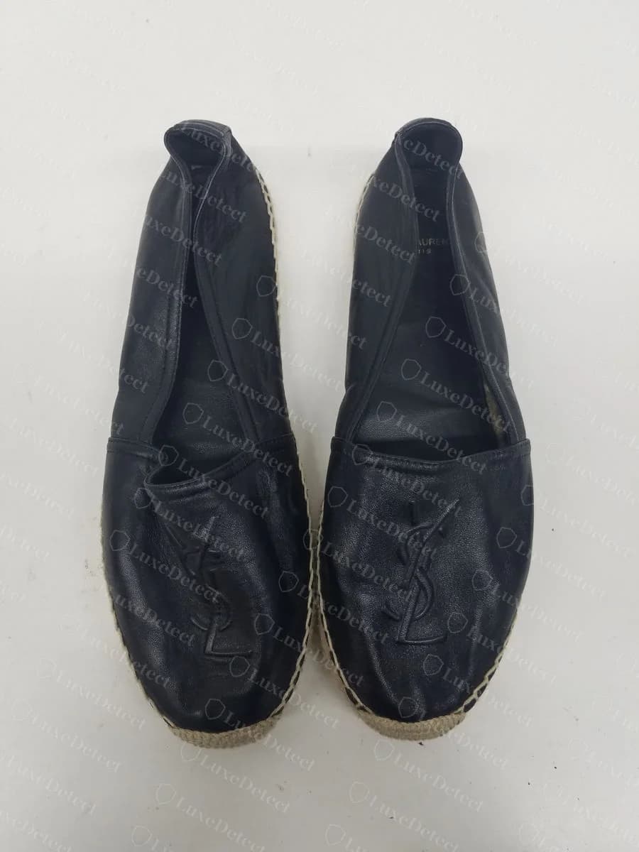 Genuine tone-on-tone debossed "YSL" monogram pressed into the leather toe of a black espadrille, with matching jute-wrapped platform sole.