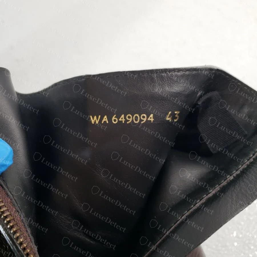 Genuine interior code "WA 649094 43" stamped in gold foil against the boot's interior lining, a separate reference from the outsole's "SAINT LAURENT PARIS" branding.