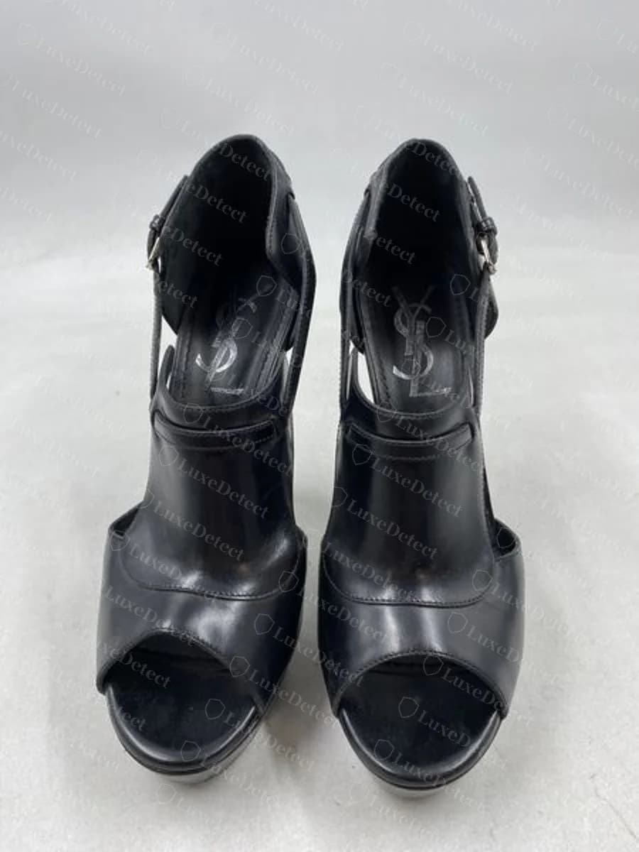 Genuine gold-tone printed "YSL" logo on the insole of a modern platform bootie, visible through the peep-toe opening, with a clean, evenly-applied print and no smudging or misregistration.