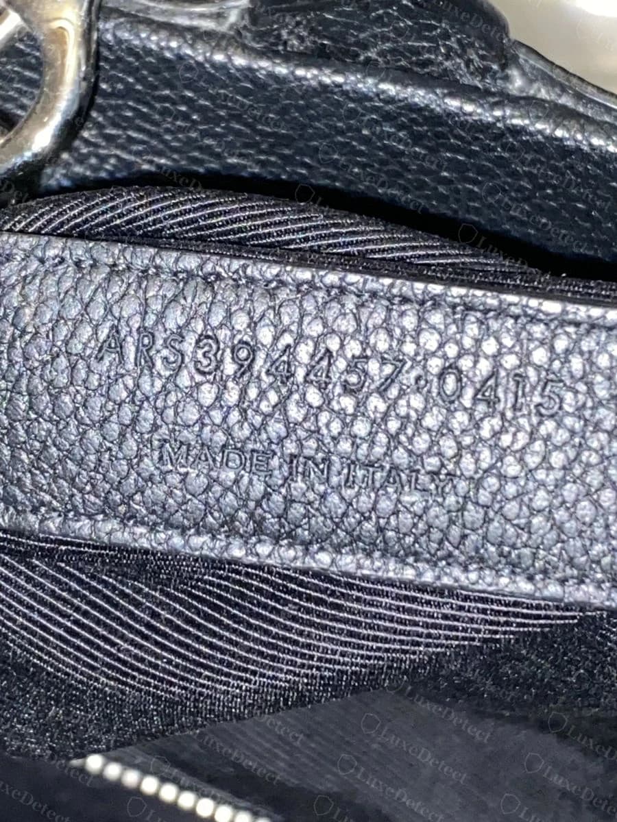Genuine date code, "ARS394457·0415, MADE IN ITALY," stamped into a leather strip near the interior seam.