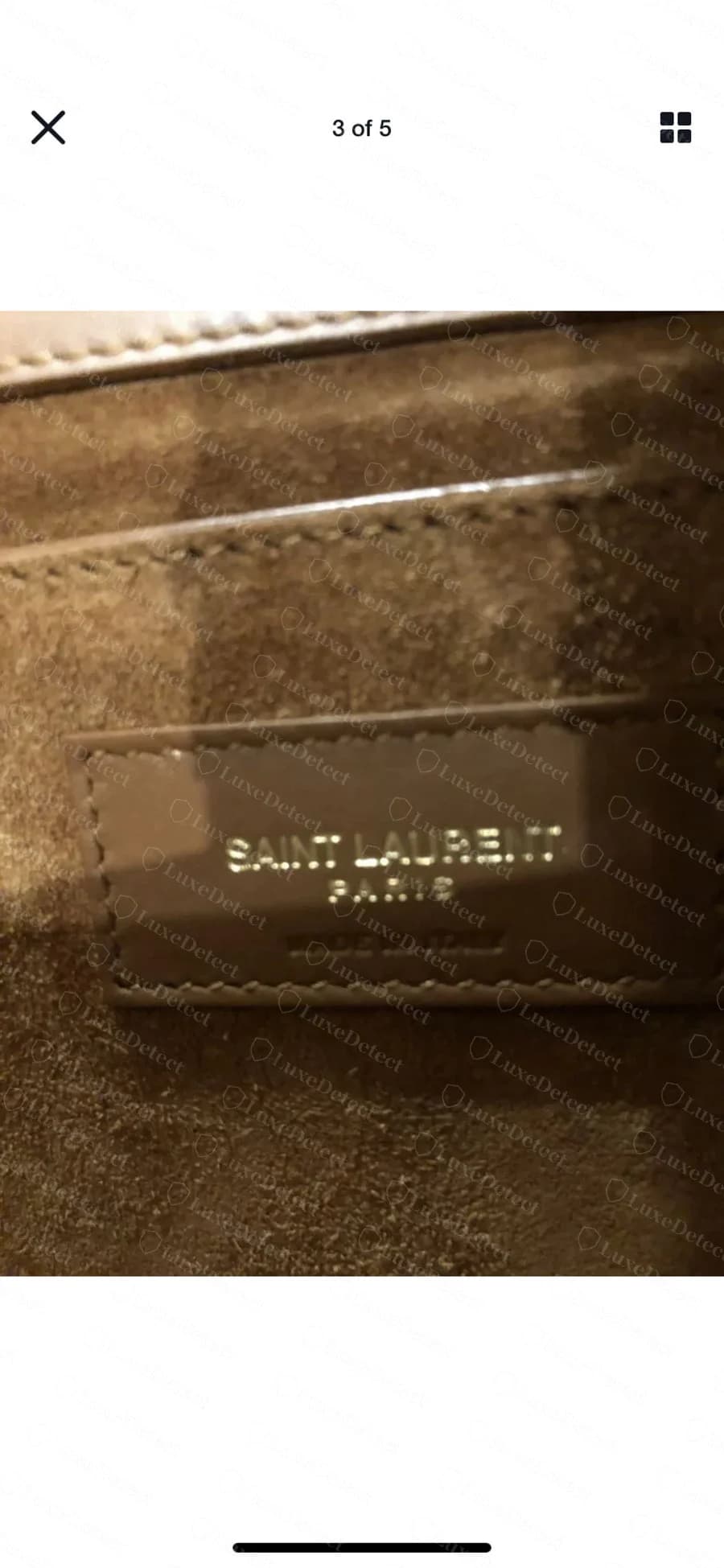 Saint Laurent Kate interior brand tag on a tan colorway, "SAINT LAURENT PARIS" foil-stamped on a leather tab stitched into the lining seam