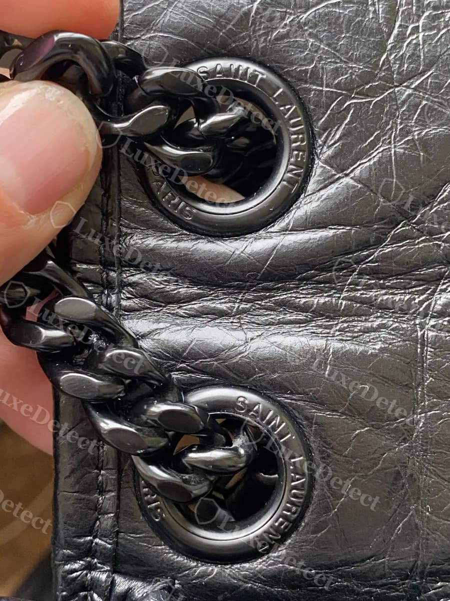 Authentic Saint Laurent Niki strap ring, engraved "SAINT LAURENT" and "PARIS" around a chain-hook ring, correct spelling and even letter spacing