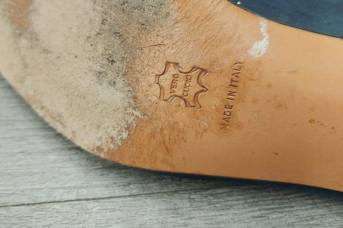 Genuine Ferragamo sole stamp — the "VERO CUOIO" leather shield mark beside "MADE IN ITALY," pressed cleanly into a tan leather sole with even, honest wear around it