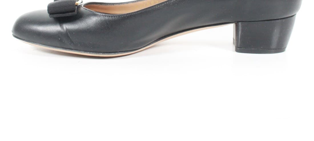 Genuine Salvatore Ferragamo Vara bow — a crisp, structured grosgrain bow with the gold Gancini-style clasp set cleanly at centre, sewn to a black leather pump