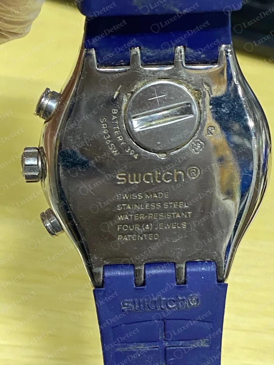 Genuine Swatch Irony chronograph steel case back with swatch above SWISS MADE, STAINLESS STEEL, WATER-RESISTANT, FOUR (4) JEWELS and PATENTED, and a battery hatch