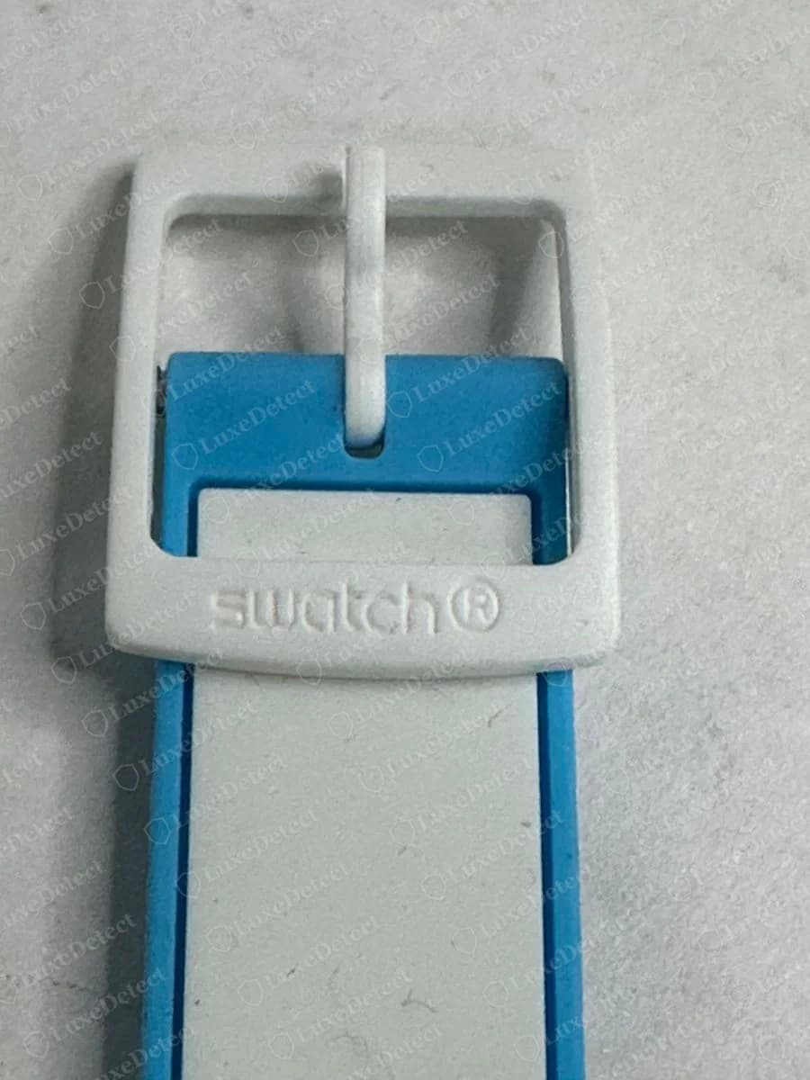 Genuine Swatch white plastic buckle with swatch and a registered mark moulded into the lower bar, on a blue and white strap