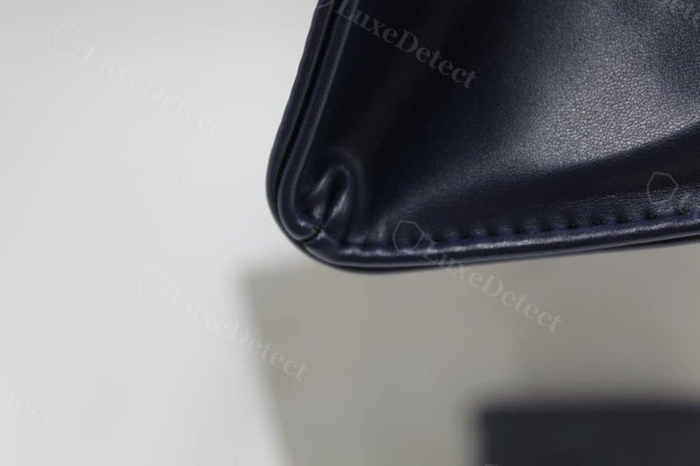 Counterfeit Telfar base seam — pinched, puckered fold right at the corner point