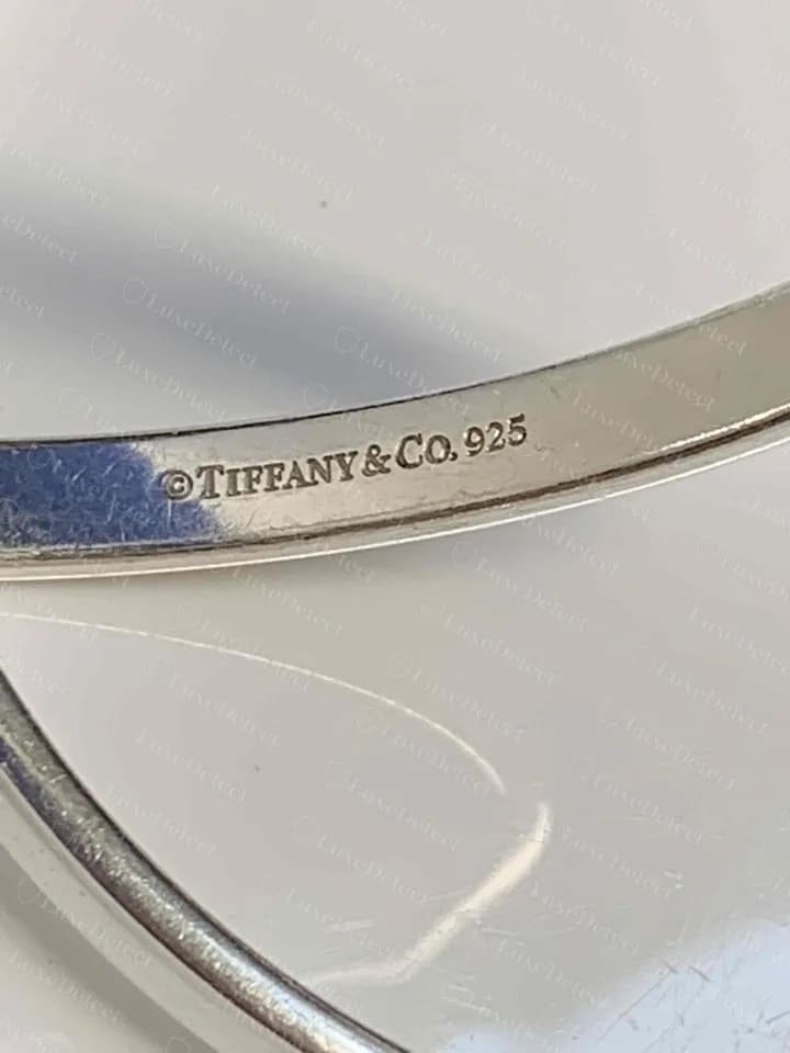 Genuine 1837 bangle, interior: a tighter line reading ©TIFFANY&Co. 925 with no year. This is a genuine variant, so tight spacing alone is not a tell.