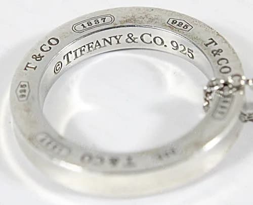 Genuine 1837 circle pendant: the rim carries T&CO, a 925 cartouche and a 1837 cartouche, and the inner face reads TIFFANY & Co. 925.