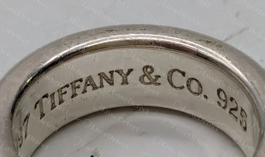 Genuine 1837 ring, interior: TIFFANY & Co. 925 engraved around the inside of the band, with a space on each side of the ampersand and before the 925.