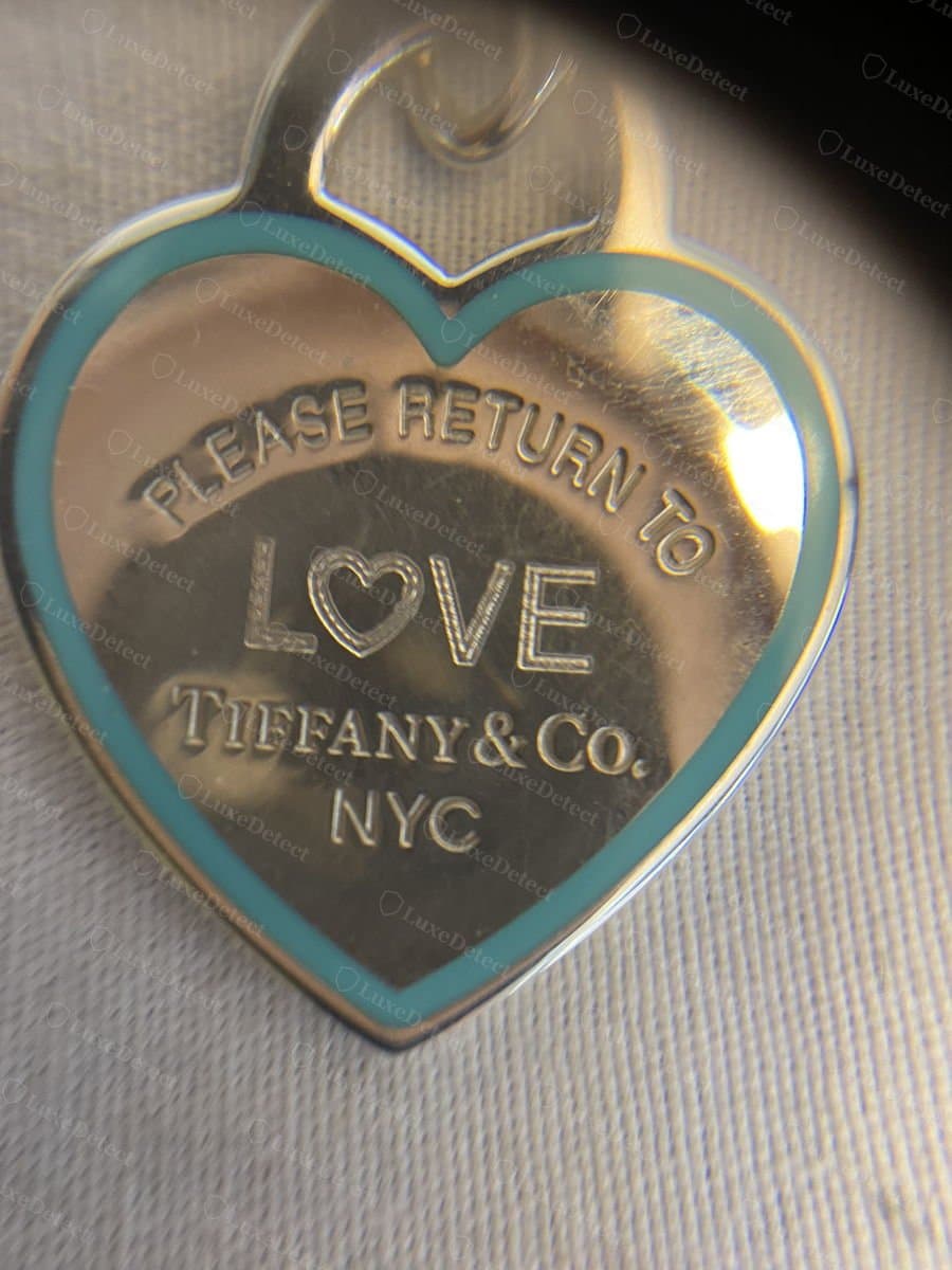 Authentic Return to Tiffany necklace: fine cable chain with a spring-ring clasp and a small oval tag stamped near the clasp.