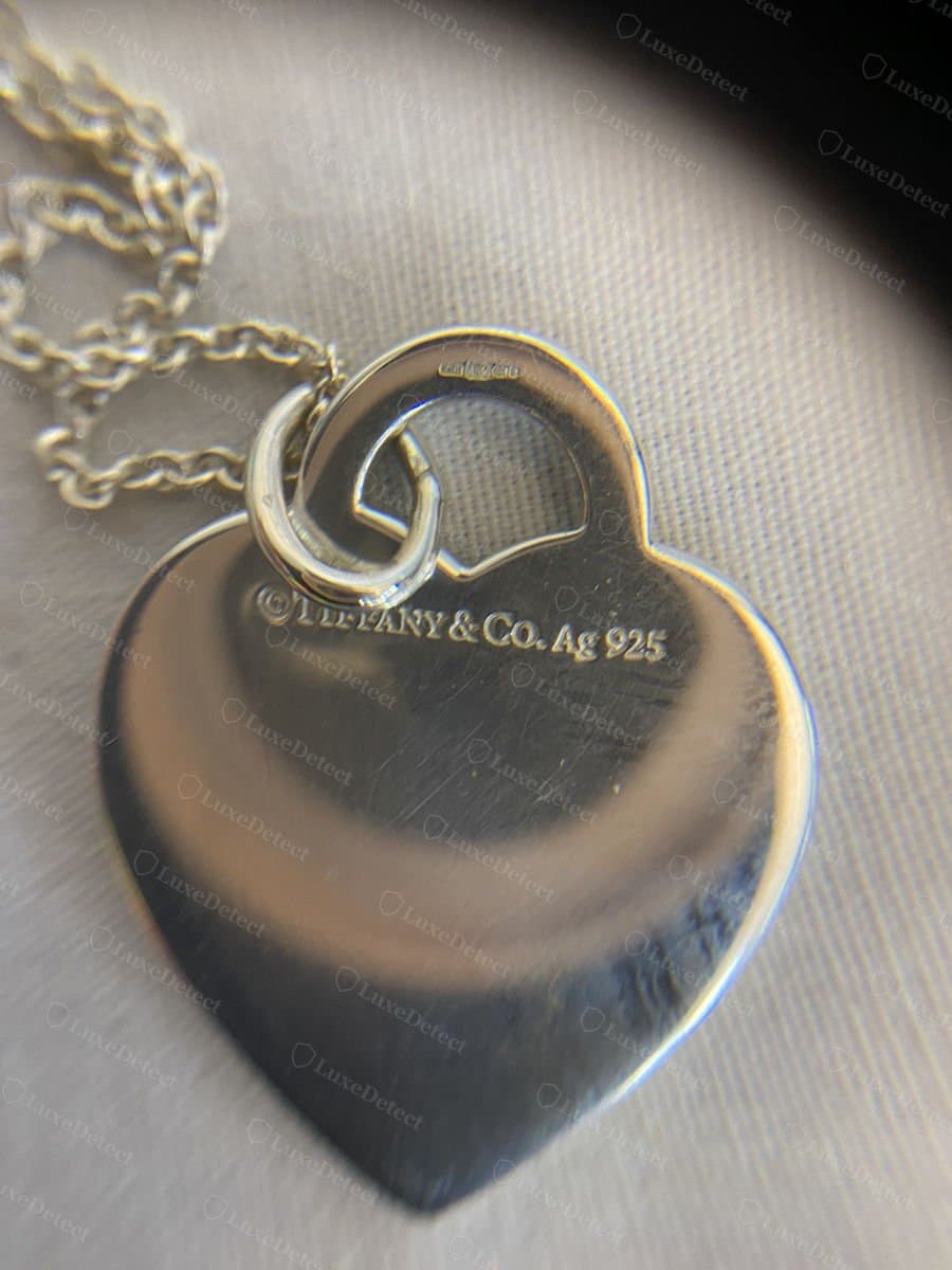 Authentic Return to Tiffany heart tag, limited "LOVE" edition, showing the engraving depth and enamel edge under magnification.