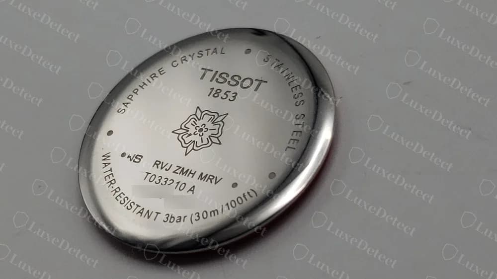 Genuine ladies Tissot caseback with a rose emblem under TISSOT 1853, SAPPHIRE CRYSTAL and STAINLESS STEEL around the edge and WATER-RESISTANT 3bar (30m/100ft). The reference and serial are partly blurred.