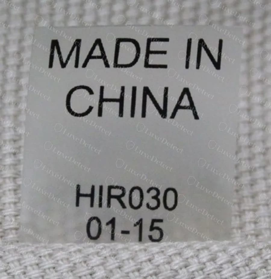 Etiqueta original de un Tory Burch Ella en mayúsculas lisas sin serifas que dicen MADE IN CHINA con el código de estilo HIR030 y la fecha 01-15 debajo