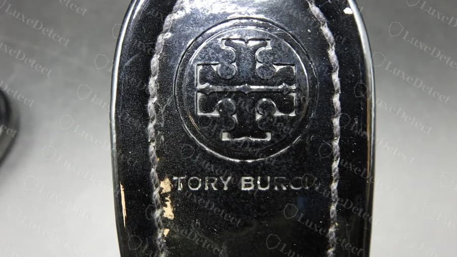 Genuine black patent Miller footbed: deep double-T circle with an evenly spaced TORY BURCH wordmark inside contrast stitching