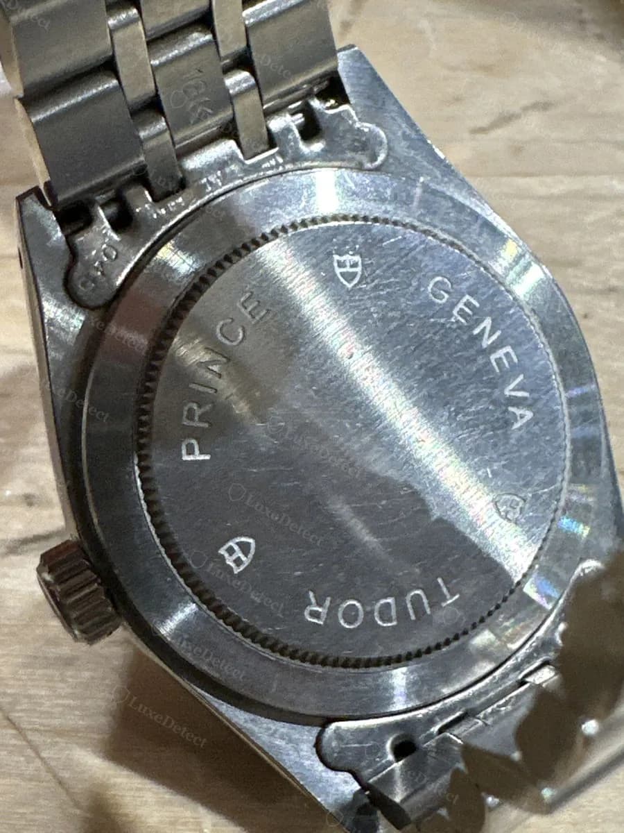 Fake Tudor Prince Date caseback: PRINCE, GENEVA, and TUDOR engraved around the edge with shield logos, on a second fake example.