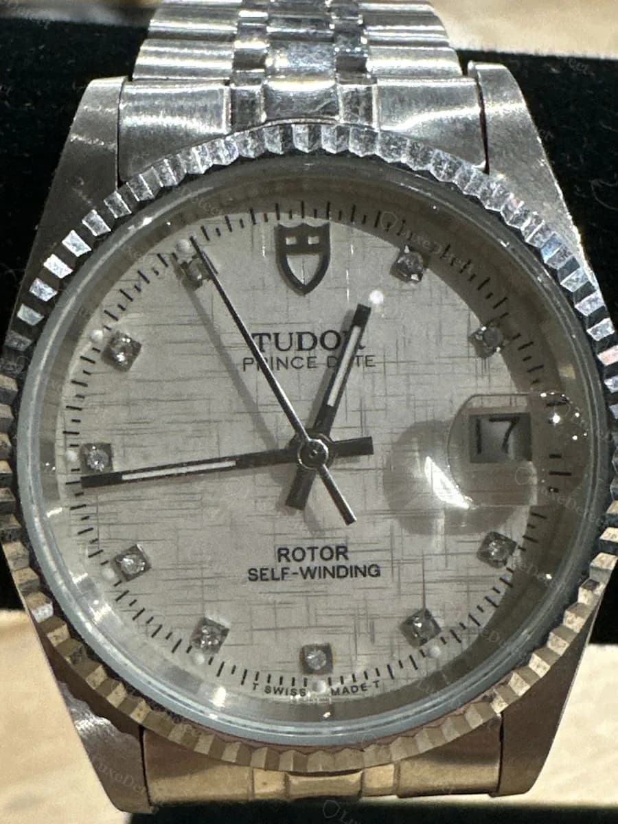 Fake Tudor Prince Date dial: fluted bezel, diamond-set hour markers, and TUDOR PRINCE DATE text beneath the shield logo.