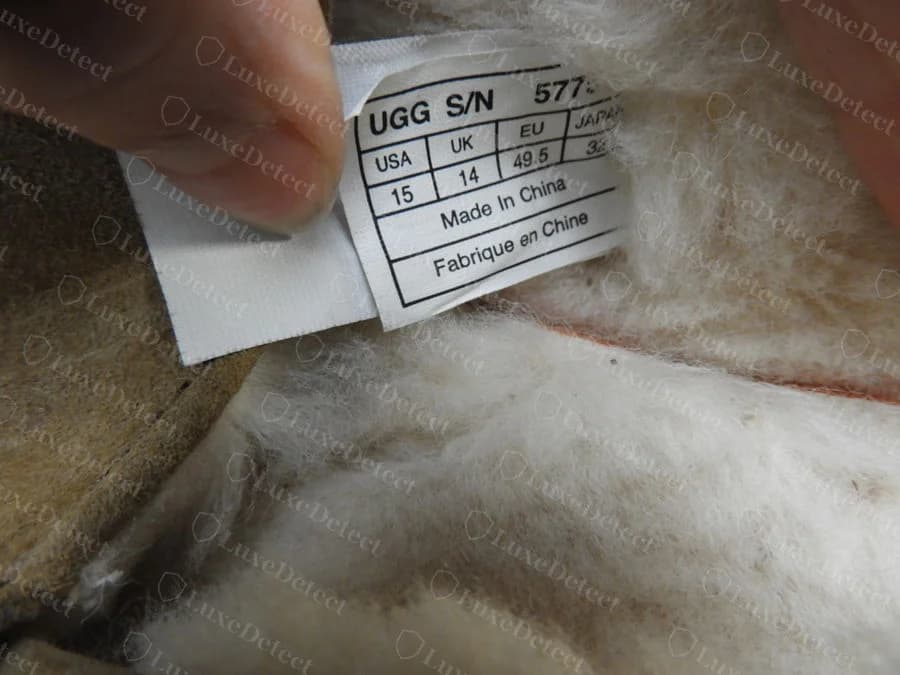 A second genuine UGG interior tag on a slipper, showing the same S/N and size-table format with Made In China, alongside the sheepskin lining