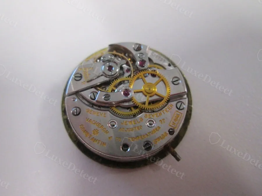 A genuine Vacheron & Constantin manual-wind movement: 17 jewels, visible mainspring barrel and gear train, engraved calibre signature — no circuit board, no battery.