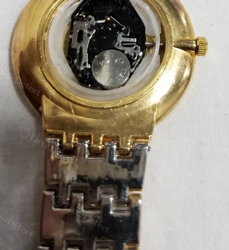 A fake sold as a "Vacheron Constantin Ladies Chronometer" opened to reveal a quartz circuit board and coin-cell battery — no mainspring, gear train or balance wheel anywhere in the case.