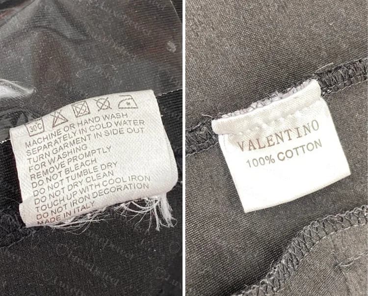 Etiqueta de cuidados Valentino falsificada só em inglês, com instruções de lavagem à máquina ou à mão, ao lado de uma etiqueta de cetim com VALENTINO 100% COTTON