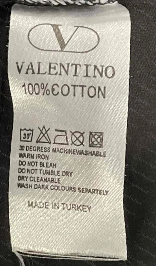 Counterfeit Valentino V-logo tag with 100% cotton, misspelled care lines and Made in Turkey