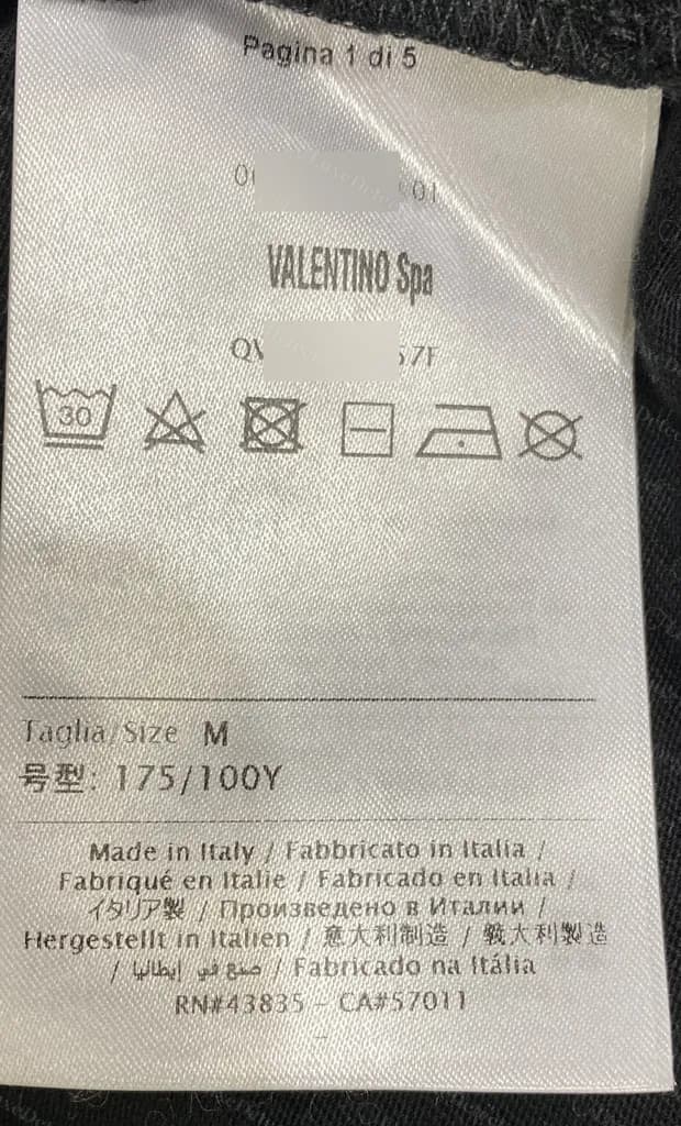 Genuine Valentino care label page one: number line, VALENTINO Spa, style code, care icons, Taglia/Size, a Chinese-character size line, origin in many languages and RN and CA numbers