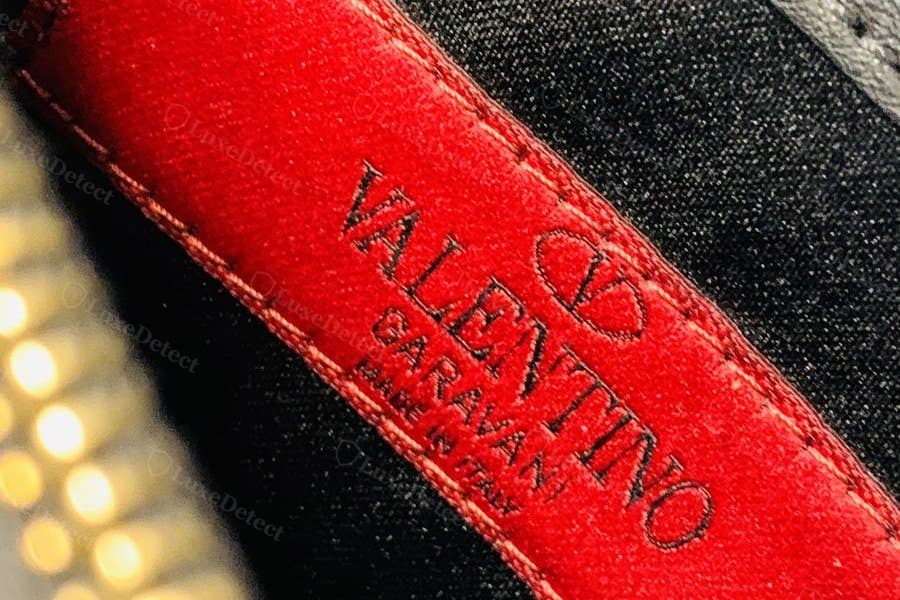 Valentino Garavani interior leather stamp, authentic debossed "VALENTINO GARAVANI MADE IN ITALY" patch (left) vs a fake patch with a closely matched layout and font (right)