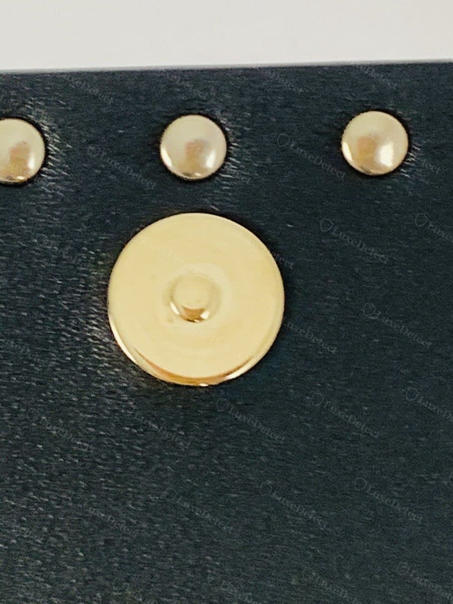 Valentino Garavani exterior debossed logo, authentic gold-stamped lettering above the stud border (left) vs a fake bag with a comparably clean logo application (right)
