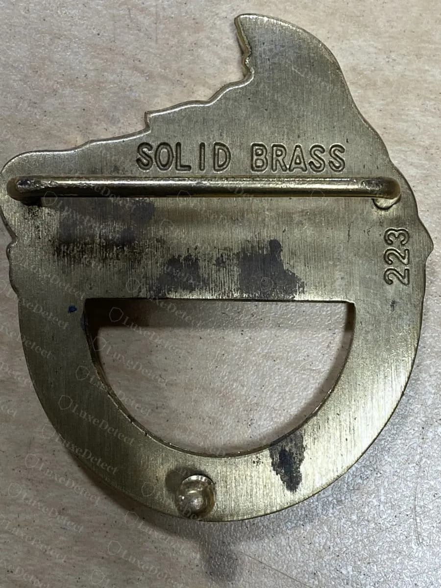 Fake-ruled Medusa buckle back stamped SOLID BRASS with the number 223 beside the bar