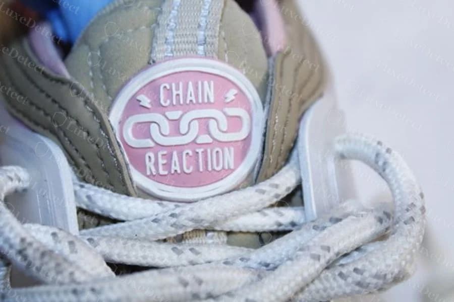 Confirmed counterfeit pair: an equally clean "Chain Reaction" tongue patch, proving the patch alone settles nothing.