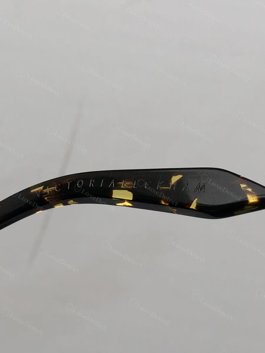 Genuine Victoria Beckham sunglasses temple arm, wordmark engraved into tortoiseshell acetate on the inside of the arm