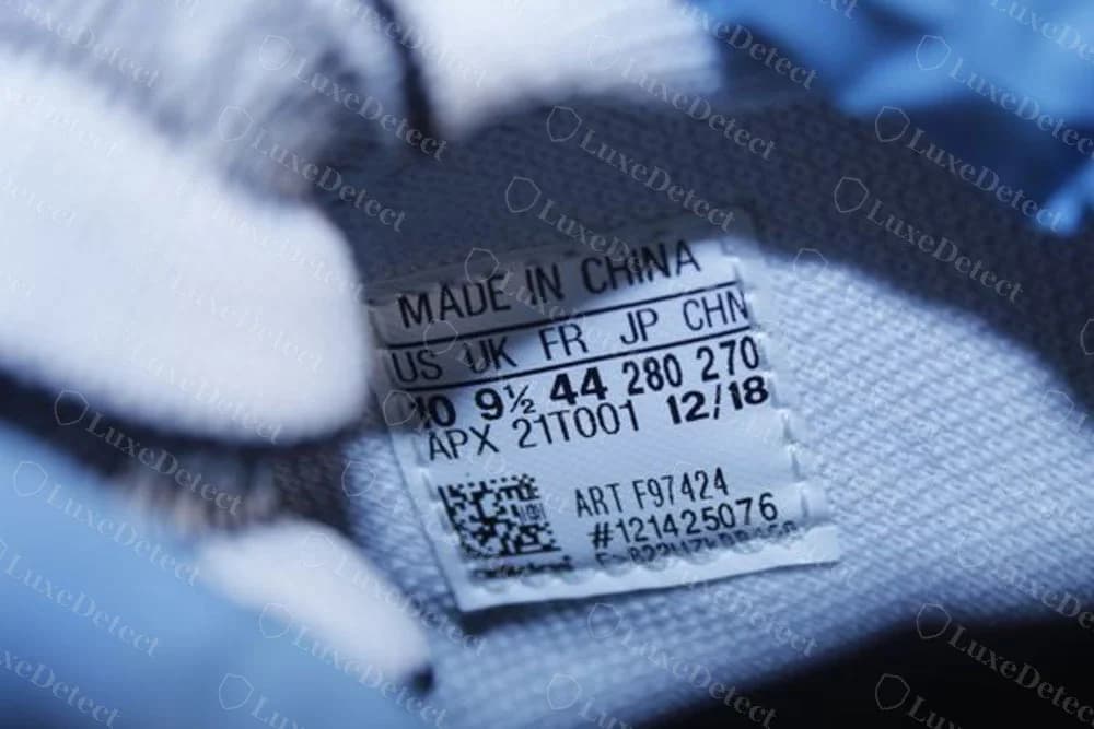 Genuine Y-3 size label from a Kaiwa, with the line APX 21T001 12/18, ART F97424 and a barcode