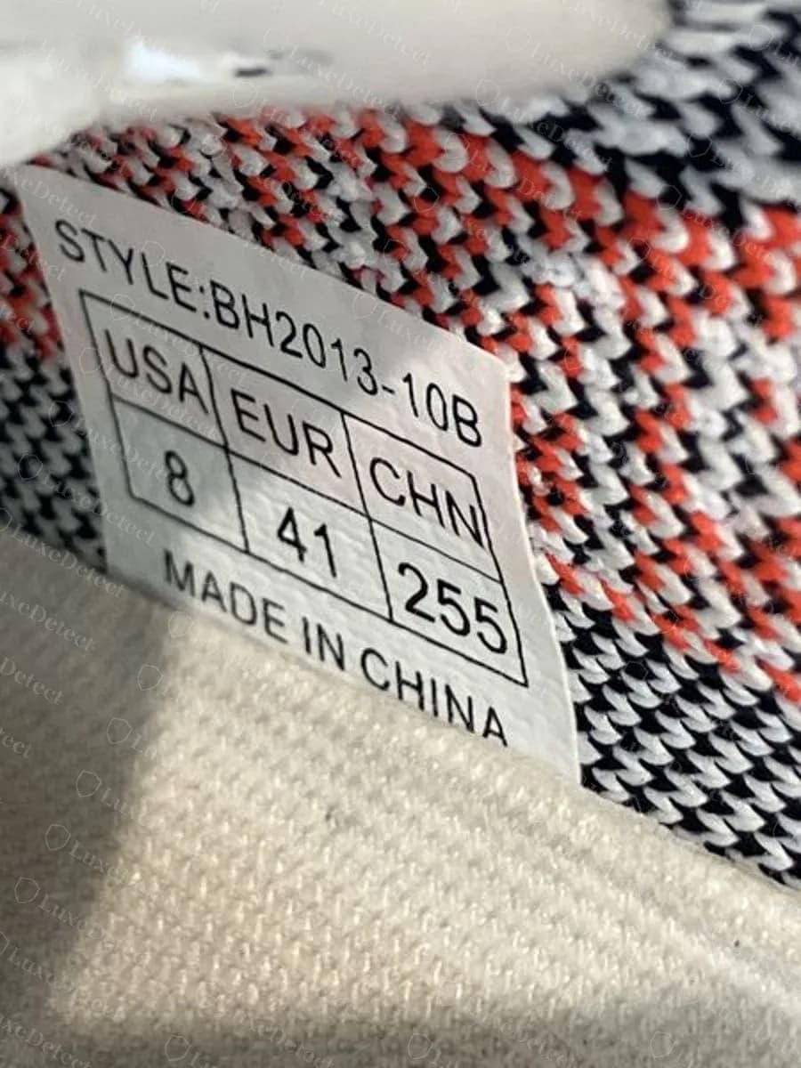 Gefälschtes Etikett im falschen Format: STYLE:BH2013-10B und ein umrandetes USA / EUR / CHN-Raster, ohne ART-Zeile, Fabrikcode, Datum oder 2D-Code