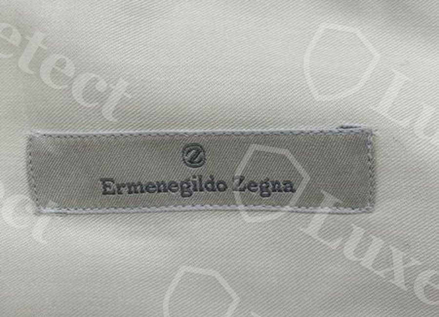 Authentic Ermenegildo Zegna dress shirt back-neck label — plain woven "Ermenegildo Zegna" wordmark, no circular Z monogram, on this particular genuine shirt